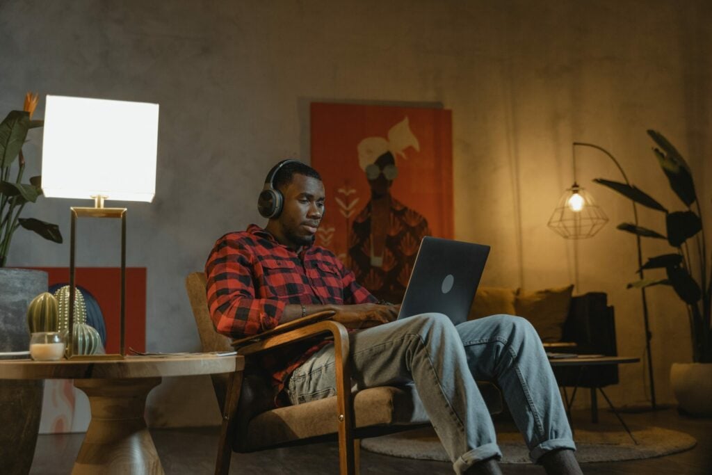 A man sat in his home using his laptop